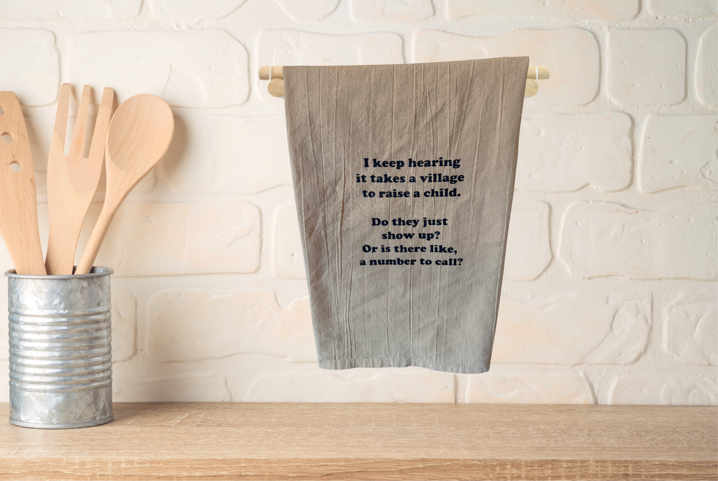 I keep hearing it take a village to raise a child kitchen towel