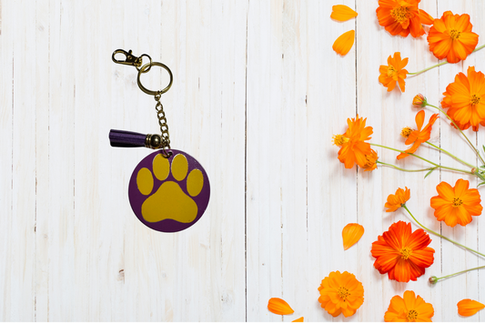 Purple keychain with yellow paw print 