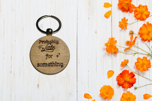 Wooden keychain with 'Probably Late for Something' text 