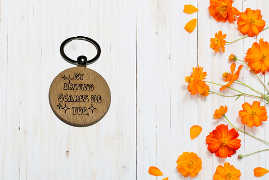 Wooden keychain with engraved text "My driving scares me too"