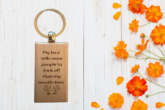 My face tells more people to fuck off than my mouth does Wood Keychain